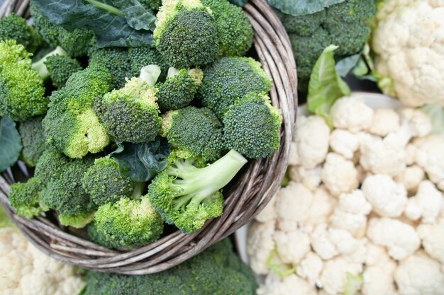 Cauliflower and broccoli in a basket on a natural green background