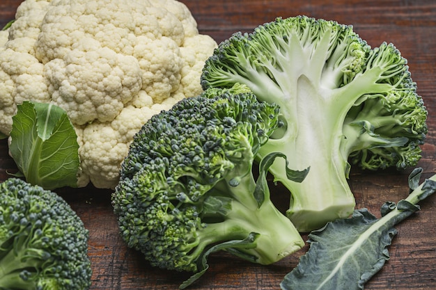 Cauliflower and broccoli on old wooden table