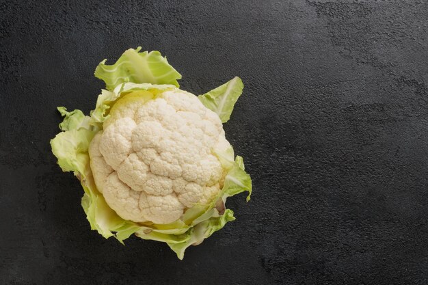 Cauliflower head on a black table