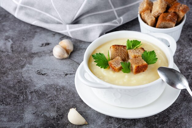 Cauliflower potato soup puree on stone background Creamy cauliflower soup