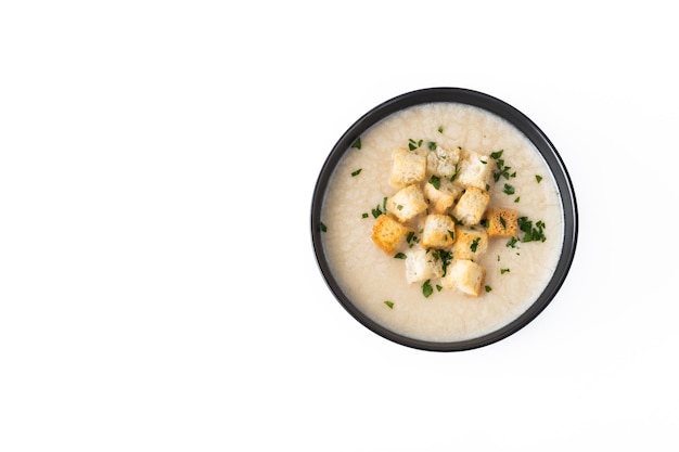 Cauliflower soup in a bowl isolated on white background