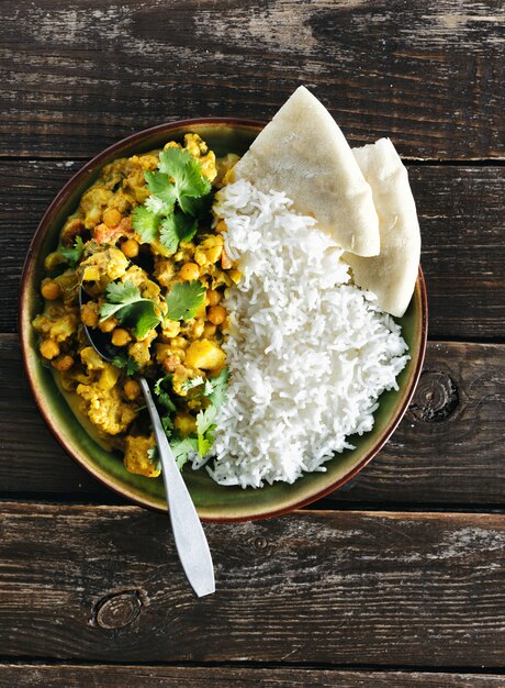 Cauliflower spicy curry rice naan bread copyspace top view