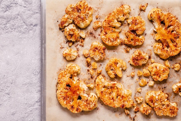 Cauliflower steak with spices cooked in the oven top view Vegetable meat substitute