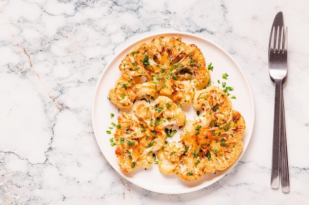 Cauliflower steak with spices cooked in the oven top view