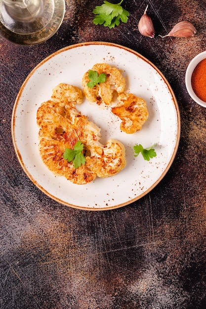 Cauliflower steak with spices cooked in the oven top view