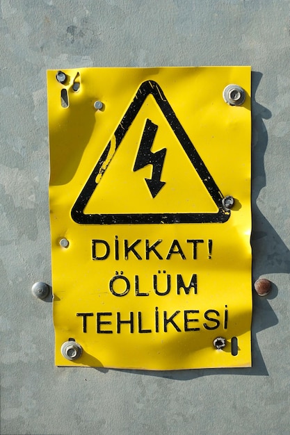 Photo caution death danger sign board with turkish fonts yellow and black sign board