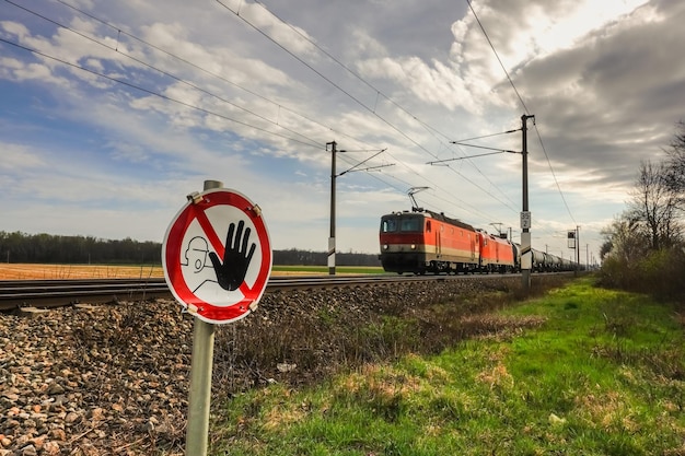 Caution sign at a crossing with an approaching fast train