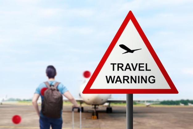 Caution sign of new variant of covid 19 omicron on the airport. Travel Warning concept