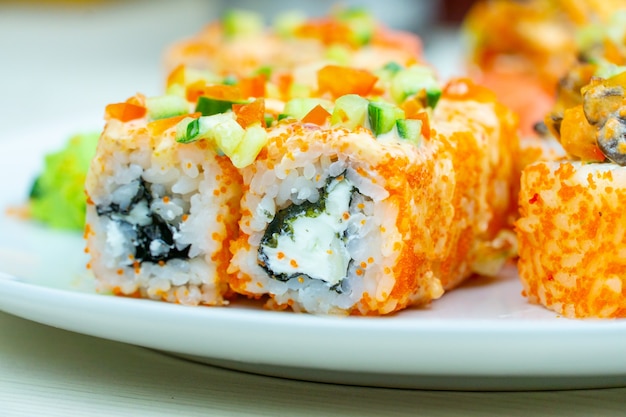 Caviar Japanese rolls with cheese filing served on a white plate