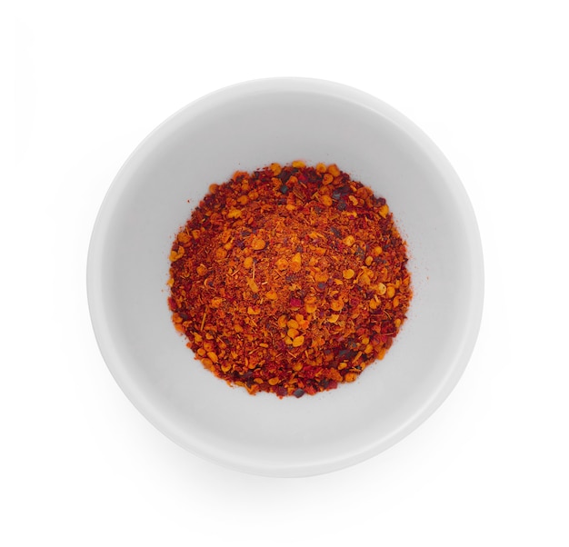 Cayenne pepper in a cup isolated on white.