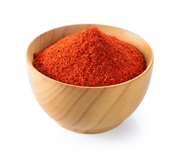 Cayenne pepper in wood bowl on white 