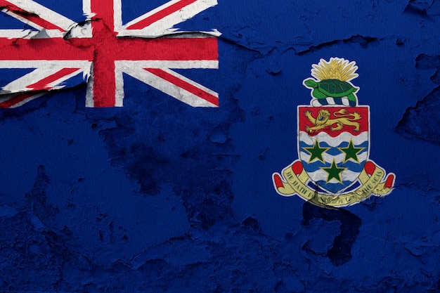 Photo cayman islands flag painted on grunge cracked wall