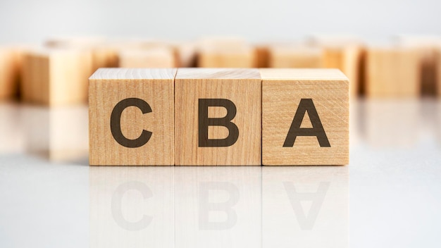 CBA word written on wood block business concept CBA short for Cost Benefit Analysis