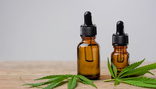 Photo cbd oil bottles and green plant of cannabis on a wooden background herbal medicine generative ai