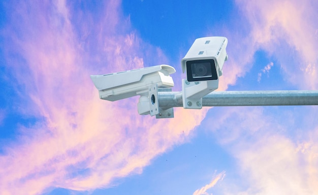 CCTV camera on bright sky background 24 hour security equipment