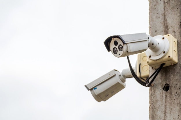 A cctv camera on electric pole watches down below important events