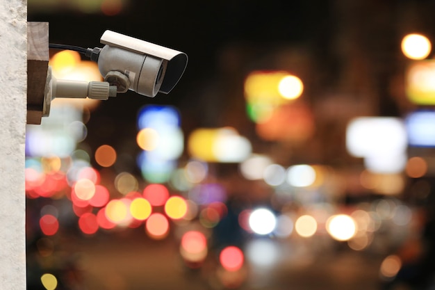 CCTV camera system on colorful bokeh of road at night background with copy space.