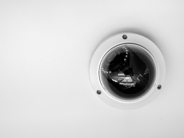 CCTV system security Closeup round CCTV camera on ceiling isolated on white background