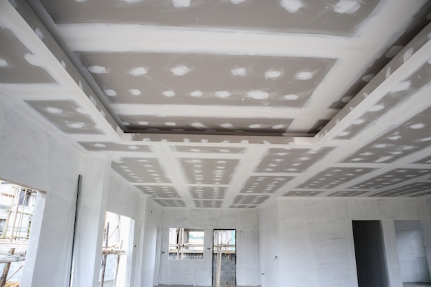 Ceiling gypsum board installation at construction site