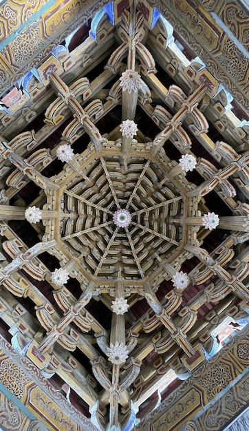 The ceiling of the temple is made of wood and has a pattern of stars.