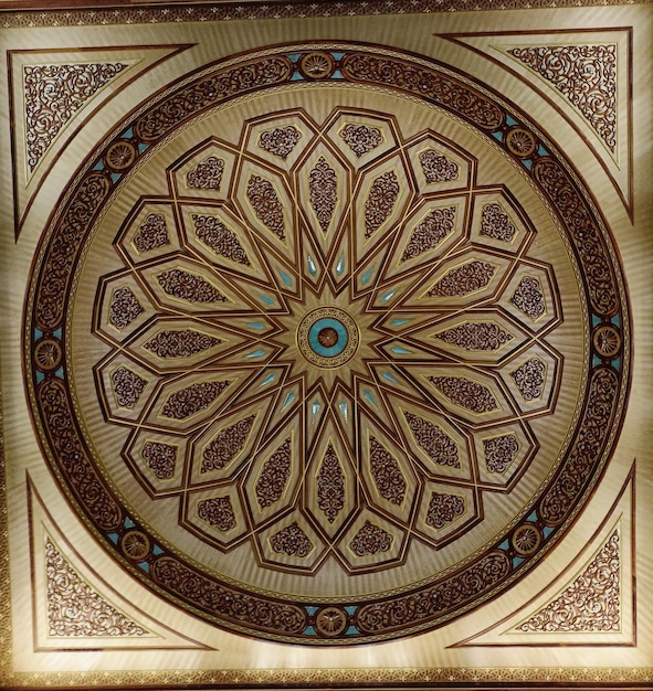 A ceiling with a floral design in the middle of it.