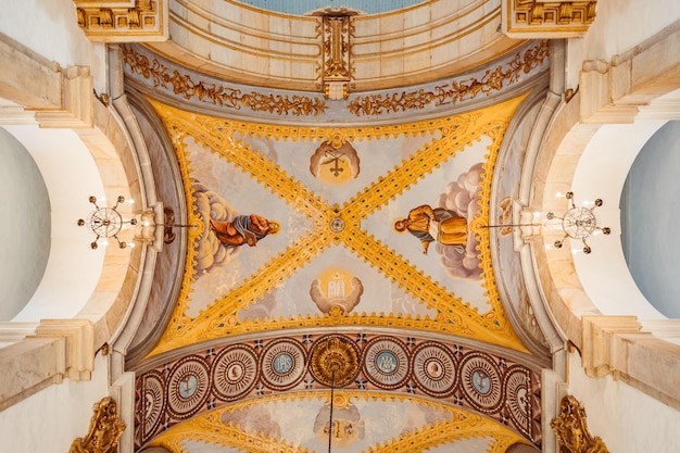 A ceiling with a painting of a man and woman on it