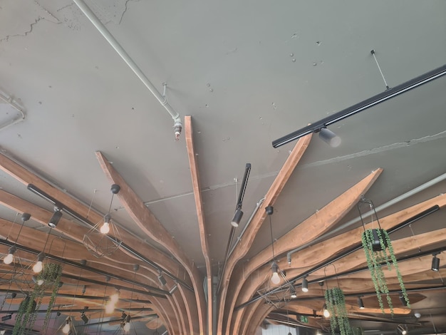 A ceiling with wood beams and a light fixture that says " the word " on it. "