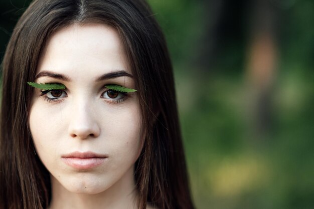 Photo celebrate earth month earth day spend time in nature connect to nature is way to mitigate climate anxiety young woman girl outdoors portrait on green nature background