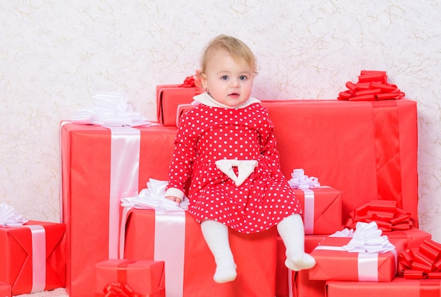 Celebrate first christmas baby first christmas once in lifetime\
event sharing joy of baby first christmas with family little baby\
girl play near pile of gift boxes gifts for child first\
christmas