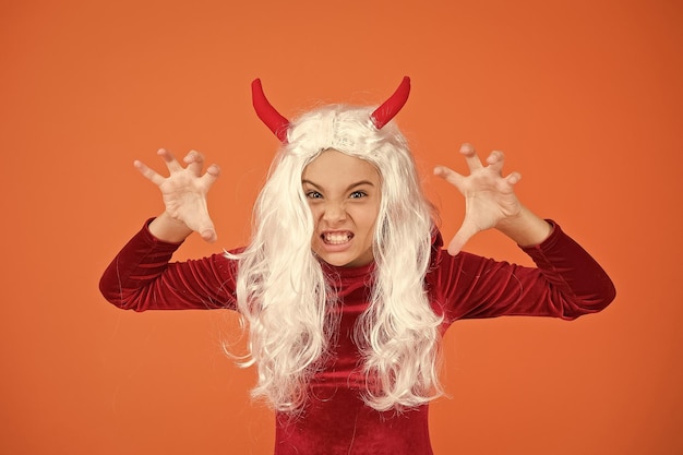 Celebrate the holidays childhood happy halloween devil girl teenage child in imp horns angry kid has white hair spooky and creepy carnival costume party trick or treat