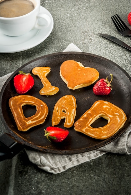 Celebrating Father's Day. Breakfast. The idea for a hearty and delicious breakfast: pancakes in form of congratulations