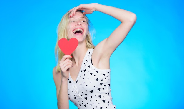 Celebrating her love. woman with decorative heart. Date. Valentines day party. Love and romance. Romantic greeting. Valentines day sales. happy woman on blue background.