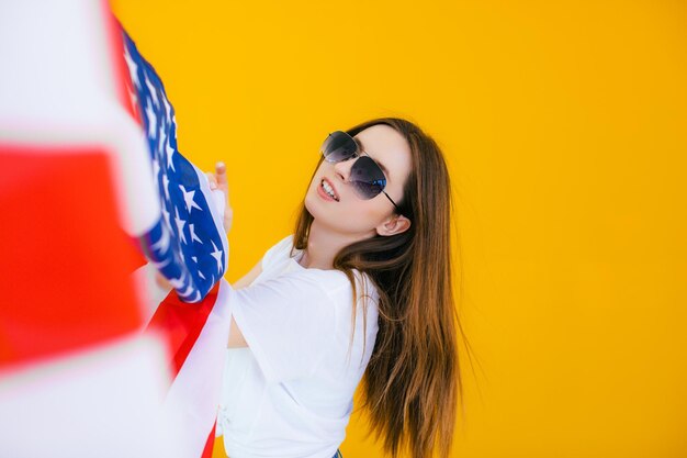 Celebrating an independence day stars and stripes young woman\
with the flag of the united states