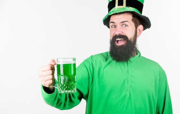 Celebrating saint patricks day Bearded man toasting to saint patricks day Hipster in leprechaun hat holding beer mug Irish man with beard drinking green beer Theres a lil bit of irish in me