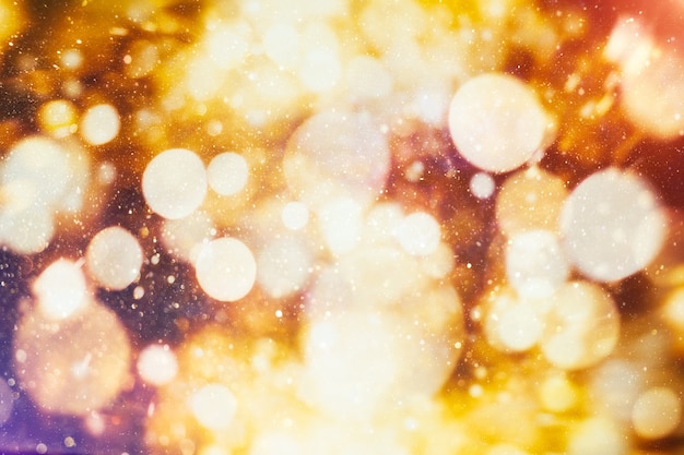 Celebration background with defocused golden lights for Christmas, New Year, Holiday, party