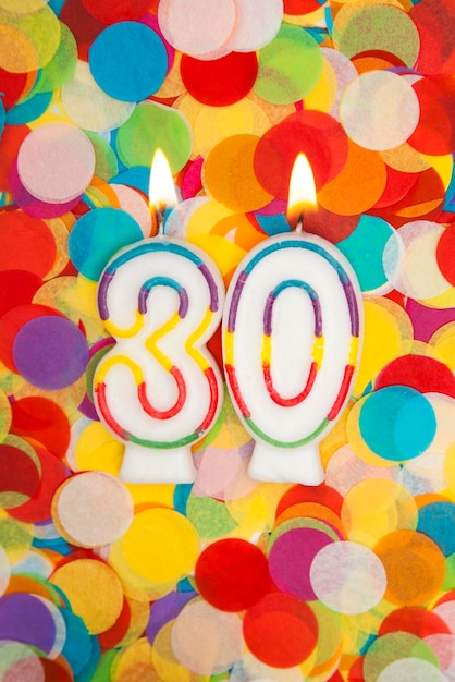 Photo celebration candle number 30 on a confetti background