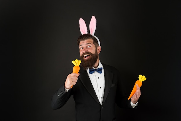 Celebration Easter holiday Carrot is good for your teeth Easter day Event host Celebrate Easter Bearded man with long ears Businessman with long ears Handsome man wear bunny costume accessory