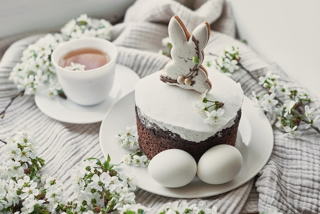 Celebration and holiday Easter cake with gingerbread homemade cake eggs Easter bunny and flowering branches postcard