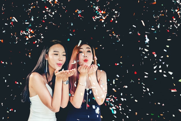 Celebration party group of asian young woman holding confetti