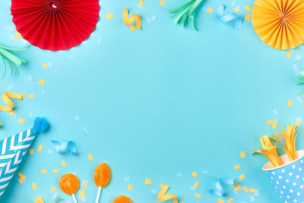 Photo celebration pattern with various party confetti on blue background. flat lay