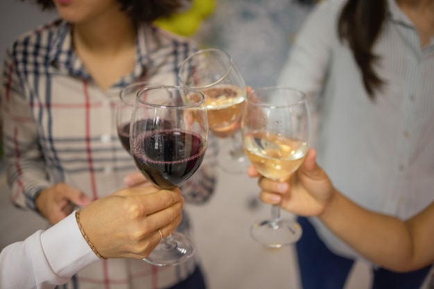 Celebration. People holding glasses of white wine making a toast.