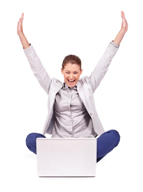 Celebration winning and businesswoman in a studio with laptop for online sports bet success Happy celebrate and professional female person with a smile and computer isolated by a white background