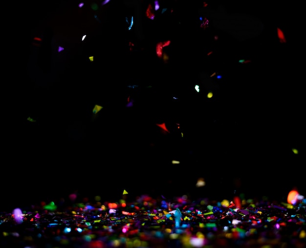 Photo celebration with colorful confetti flying , isolated on back background