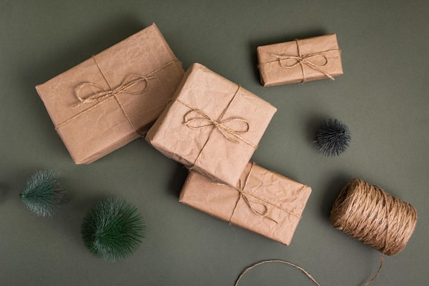 Celebratory christmas and new years holidays background gift boxes wrapped craft paper with twine  r...