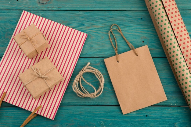 Celebratory concept set with handmade striped shopping bag gift bags packing paper with polka dots