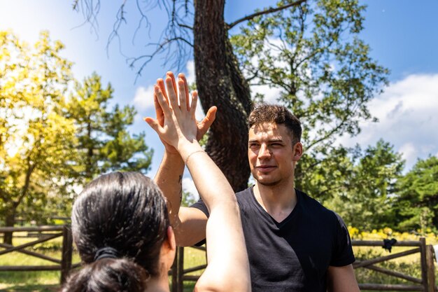 Celebratory highfive in outdoor fitness session