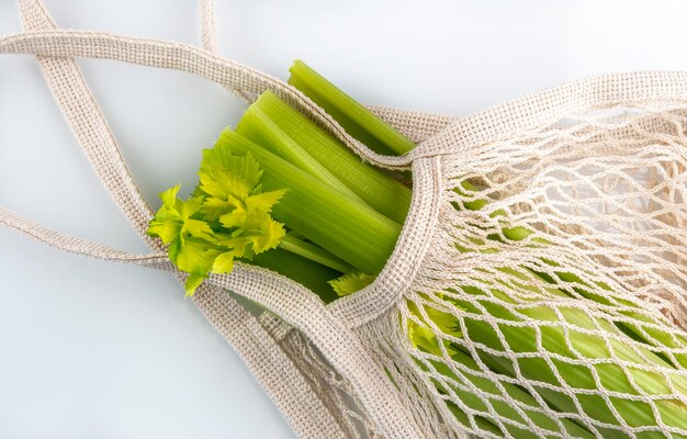 Celery in an organic bag on the white background