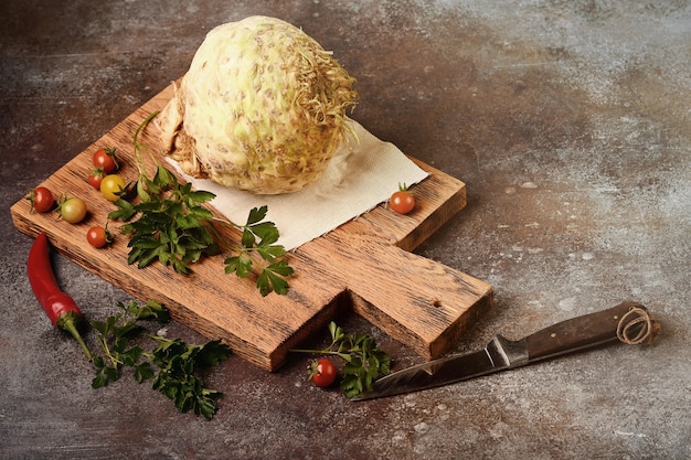 Celery root on wooden cutting board.