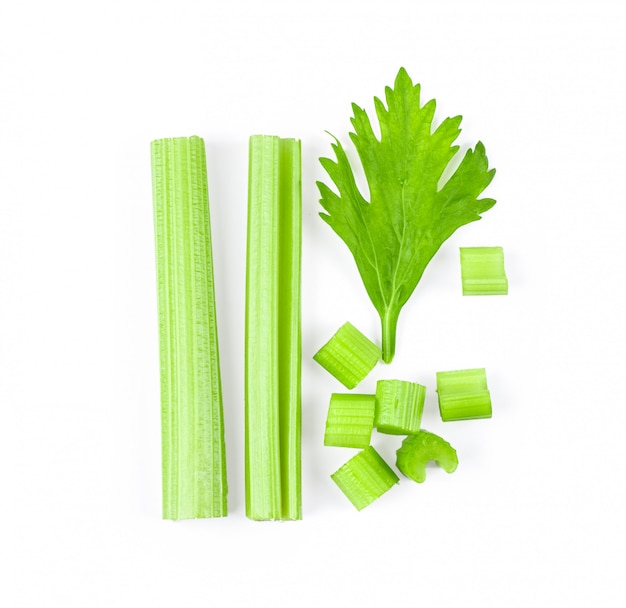 Celery sticks on white table.