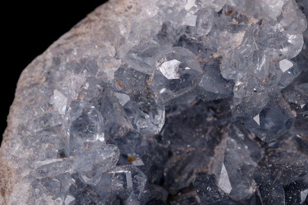 Celestine mineral stone macro on microcline on black background